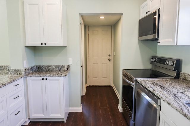 214 Moull St, Newark, OH 43055 - kitchen featuring appliances with stainless steel finishes, white cabinets, dark wood-style flooring, and recessed lighting