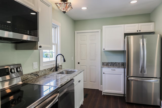 214 Moull St, Newark, OH 43055 - kitchen with stainless steel appliances, white cabinetry, light stone counters, dark wood-style flooring, and recessed lighting