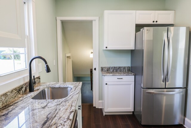 214 Moull St, Newark, OH 43055 - kitchen with freestanding refrigerator, white cabinetry, light stone countertops, and dark wood finished floors