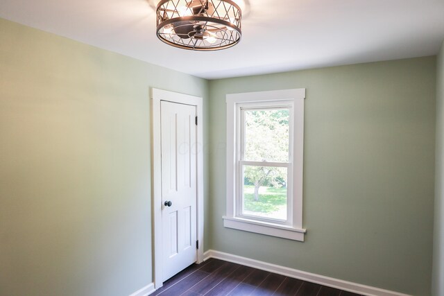 214 Moull St, Newark, OH 43055 - empty room featuring dark wood-style flooring and a chandelier
