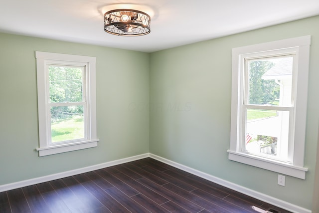 214 Moull St, Newark, OH 43055 - spare room featuring dark wood-style flooring and a chandelier