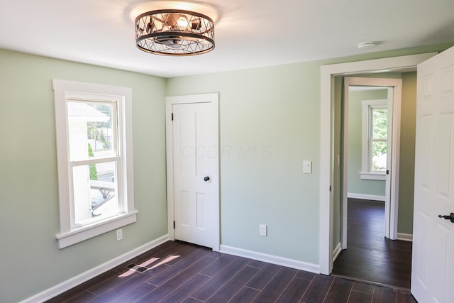 214 Moull St, Newark, OH 43055 - unfurnished bedroom featuring dark wood-style floors, a chandelier, and a closet