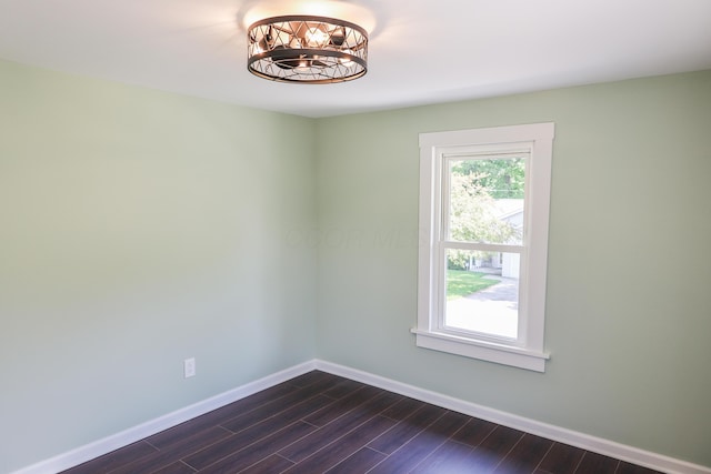 214 Moull St, Newark, OH 43055 - empty room with dark wood-style flooring and a chandelier