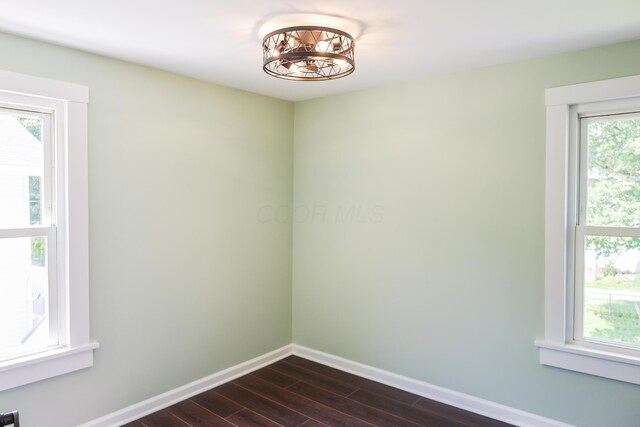 214 Moull St, Newark, OH 43055 - spare room featuring dark wood-style floors and a chandelier