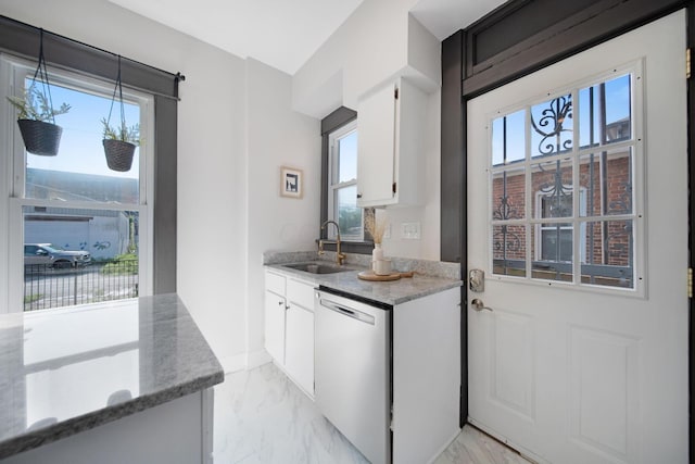 1214 Hamlet St, Columbus, OH 43201 - kitchen with stainless steel dishwasher, light marble finish floors, and plenty of natural light
