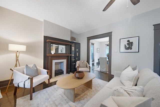 1214 Hamlet St, Columbus, OH 43201 - living room with wood finished floors, a fireplace with flush hearth, and a ceiling fan