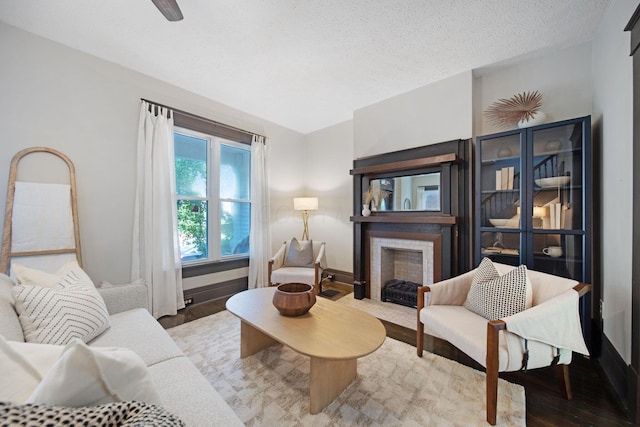 1214 Hamlet St, Columbus, OH 43201 - living room featuring a fireplace with flush hearth, wood finished floors, and a textured ceiling