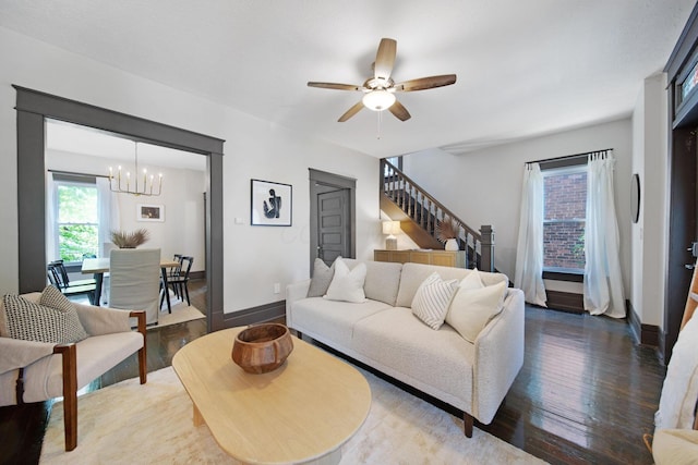 1214 Hamlet St, Columbus, OH 43201 - living area featuring wood finished floors, a chandelier, ceiling fan, and stairs
