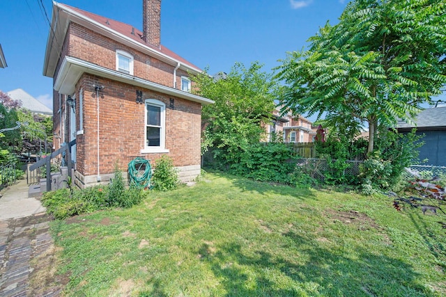 1214 Hamlet St, Columbus, OH 43201 - rear view of property featuring brick siding and a chimney