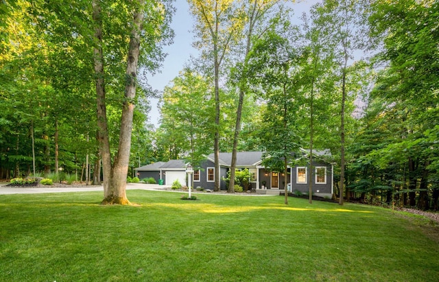 525 Floral Valley Dr W, Howard, OH 43028 - view of green lawn with concrete driveway and a garage