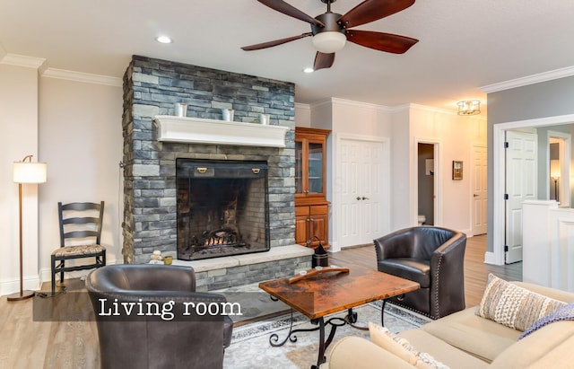 525 Floral Valley Dr W, Howard, OH 43028 - living room with wood finished floors, ceiling fan, ornamental molding, a stone fireplace, and recessed lighting
