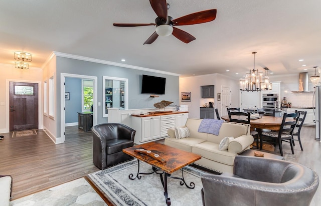 525 Floral Valley Dr W, Howard, OH 43028 - living area with a chandelier, light wood finished floors, a ceiling fan, ornamental molding, and recessed lighting