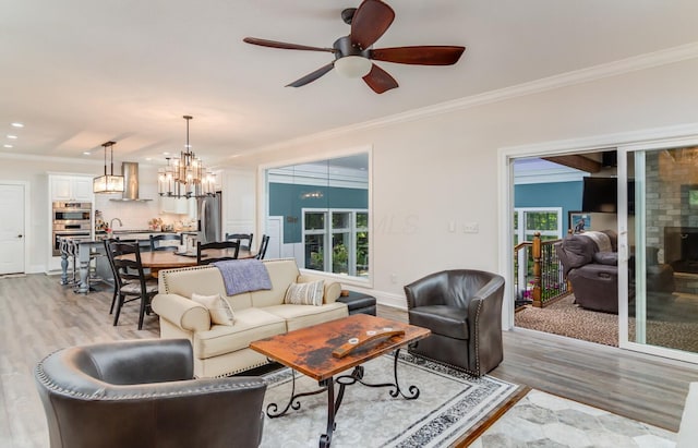 525 Floral Valley Dr W, Howard, OH 43028 - living room with light wood-style flooring, crown molding, a ceiling fan, a chandelier, and recessed lighting