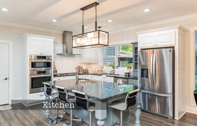 525 Floral Valley Dr W, Howard, OH 43028 - kitchen with stainless steel appliances, wall chimney range hood, dark wood-style floors, ornamental molding, and white cabinets