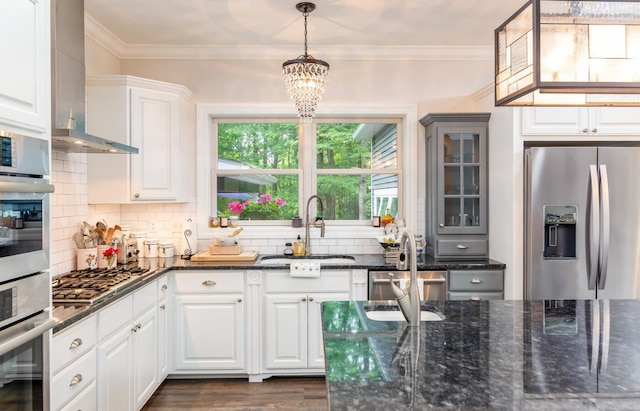 525 Floral Valley Dr W, Howard, OH 43028 - kitchen with appliances with stainless steel finishes, decorative backsplash, a chandelier, dark stone counters, and pendant lighting