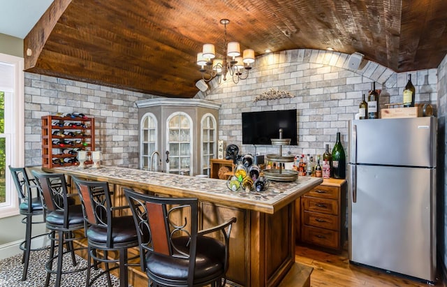 525 Floral Valley Dr W, Howard, OH 43028 - indoor bar with freestanding refrigerator, vaulted ceiling, wood finished floors, wooden ceiling, and healthy amount of natural light