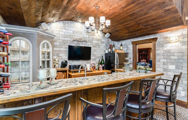 525 Floral Valley Dr W, Howard, OH 43028 - bar area featuring freestanding refrigerator, lofted ceiling, wooden ceiling, a chandelier, and wood finished floors