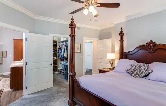 525 Floral Valley Dr W, Howard, OH 43028 - bedroom with a walk in closet, crown molding, a closet, ensuite bath, and a ceiling fan