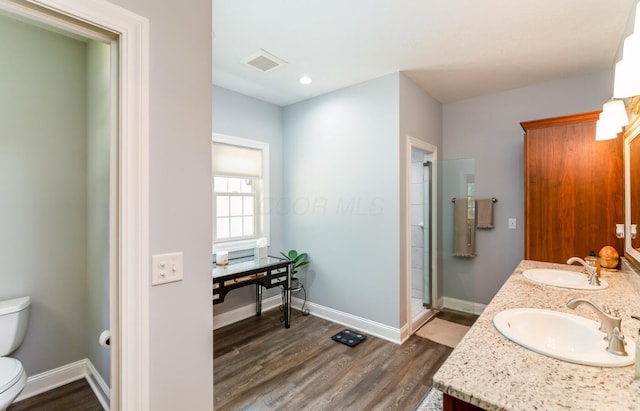 525 Floral Valley Dr W, Howard, OH 43028 - bathroom with double vanity, wood finished floors, and a stall shower