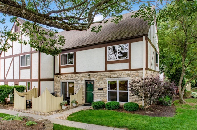 1573 Arlington Ave, Marble Cliff, OH 43212 - tudor house featuring stone siding, stucco siding, roof with shingles, and a front lawn