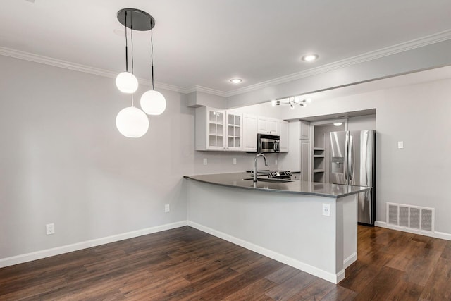 1573 Arlington Ave, Marble Cliff, OH 43212 - kitchen with appliances with stainless steel finishes, a peninsula, glass insert cabinets, dark wood-style floors, and ornamental molding