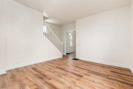 479 Siebert St, Columbus, OH 43206 - unfurnished room featuring wood finished floors, stairway, and baseboards