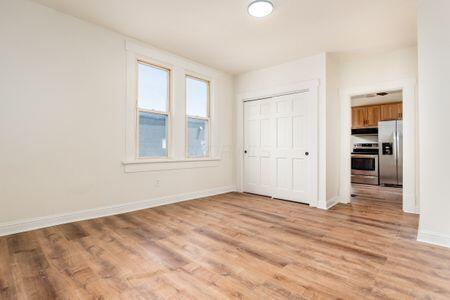 479 Siebert St, Columbus, OH 43206 - unfurnished bedroom with stainless steel fridge with ice dispenser, light wood-type flooring, baseboards, and a closet