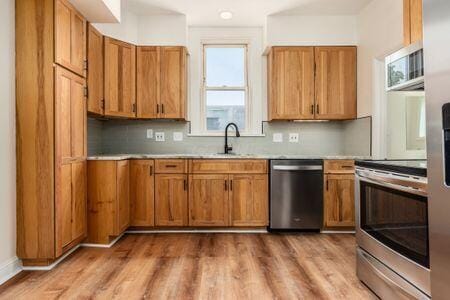 479 Siebert St, Columbus, OH 43206 - kitchen with appliances with stainless steel finishes, a sink, and brown cabinetry