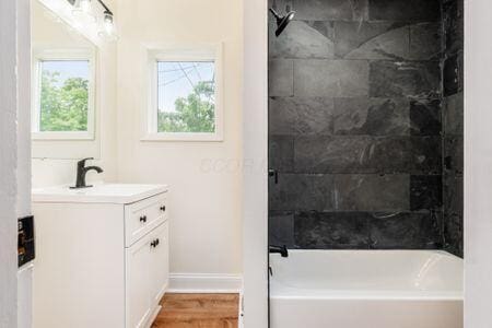 479 Siebert St, Columbus, OH 43206 - bathroom featuring vanity, baseboards, shower / bath combination, and wood finished floors