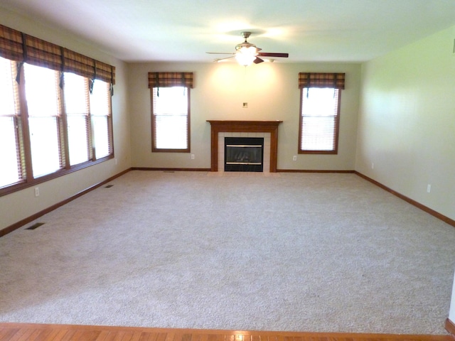 2360 Rufus Ct, Lewis Center, OH 43035 - unfurnished living room featuring healthy amount of natural light, ceiling fan, a fireplace, and light carpet