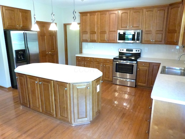 2360 Rufus Ct, Lewis Center, OH 43035 - kitchen featuring appliances with stainless steel finishes, light wood-style floors, a center island, light countertops, and brown cabinets