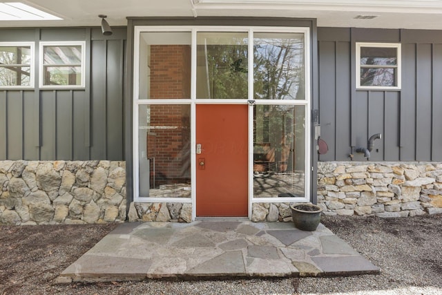 220 Hardy Way, Worthington, OH 43085 - doorway to property with board and batten siding and stone siding