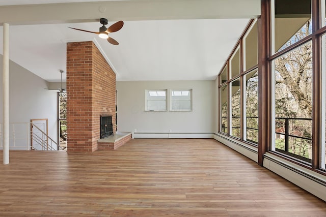 220 Hardy Way, Worthington, OH 43085 - unfurnished living room featuring vaulted ceiling, ceiling fan, wood finished floors, and a fireplace