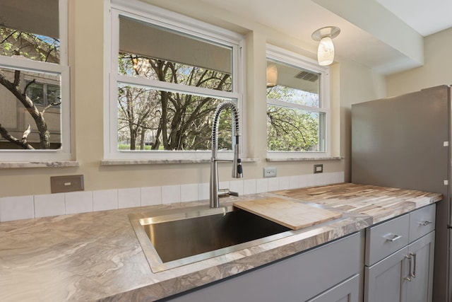 220 Hardy Way, Worthington, OH 43085 - kitchen featuring a sink, butcher block countertops, gray cabinetry, and freestanding refrigerator