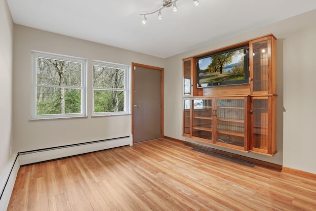 220 Hardy Way, Worthington, OH 43085 - spare room with light wood-style floors and a baseboard radiator