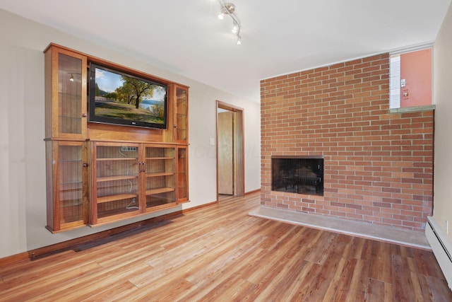 220 Hardy Way, Worthington, OH 43085 - unfurnished living room with a baseboard heating unit, light wood-style flooring, and a fireplace