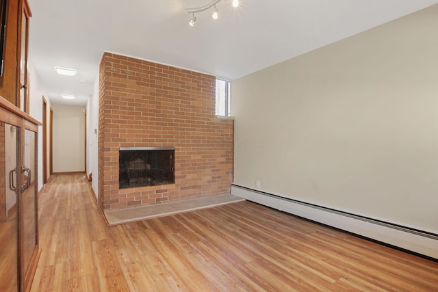 220 Hardy Way, Worthington, OH 43085 - unfurnished living room with a baseboard heating unit, light wood-style flooring, and a fireplace