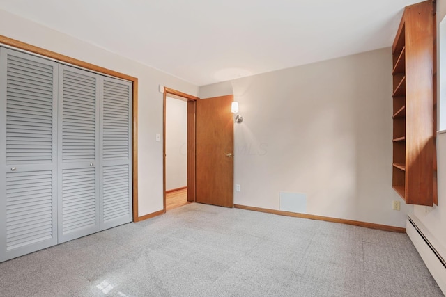 220 Hardy Way, Worthington, OH 43085 - unfurnished bedroom featuring a baseboard heating unit, a closet, carpet, and baseboards