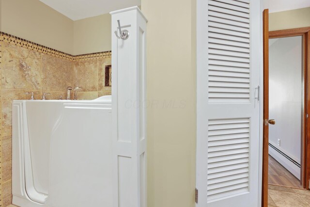 220 Hardy Way, Worthington, OH 43085 - bathroom with a baseboard radiator and tile patterned floors