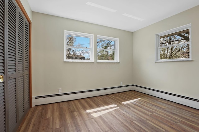 220 Hardy Way, Worthington, OH 43085 - unfurnished bedroom with wood finished floors, a closet, and multiple windows