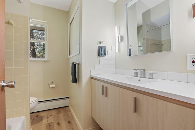 220 Hardy Way, Worthington, OH 43085 - full bathroom featuring baseboard heating, toilet, wood finished floors, vanity, and a shower