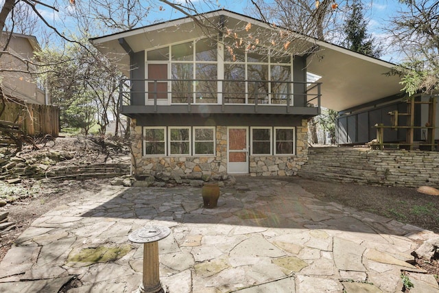 220 Hardy Way, Worthington, OH 43085 - back of house with stone siding, a patio, and a balcony