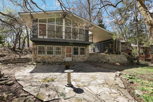 220 Hardy Way, Worthington, OH 43085 - back of house featuring stone siding, a patio area, and a balcony