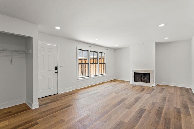 251 E Kossuth St Unit A, Columbus, OH 43206 - unfurnished living room featuring wood finished floors, a fireplace, and recessed lighting