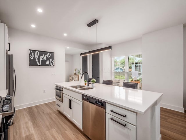 1210 Madison Ave, Columbus, OH 43205 - kitchen with stainless steel appliances, white cabinets, light wood-type flooring, light countertops, and recessed lighting