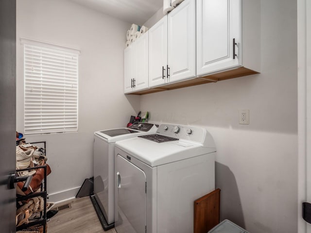 1210 Madison Ave, Columbus, OH 43205 - laundry area with washer and dryer, light wood-style floors, and cabinet space