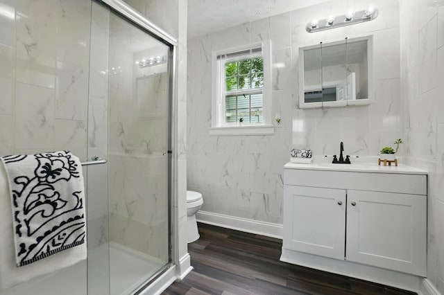 2718 Lagonda Ave, Springfield, OH 45503 - full bathroom featuring vanity, a marble finish shower, toilet, wood finished floors, and a textured ceiling