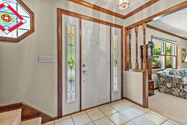 1212 Autumn Creek Cir, Westerville, OH 43081 - foyer entrance with ornamental molding, light tile patterned floors, light colored carpet, and a chandelier