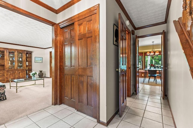 1212 Autumn Creek Cir, Westerville, OH 43081 - hall with crown molding, light tile patterned floors, a textured ceiling, light colored carpet, and a chandelier