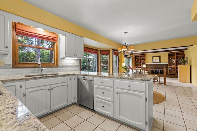 1212 Autumn Creek Cir, Westerville, OH 43081 - kitchen featuring stainless steel dishwasher, light tile patterned flooring, a peninsula, and backsplash